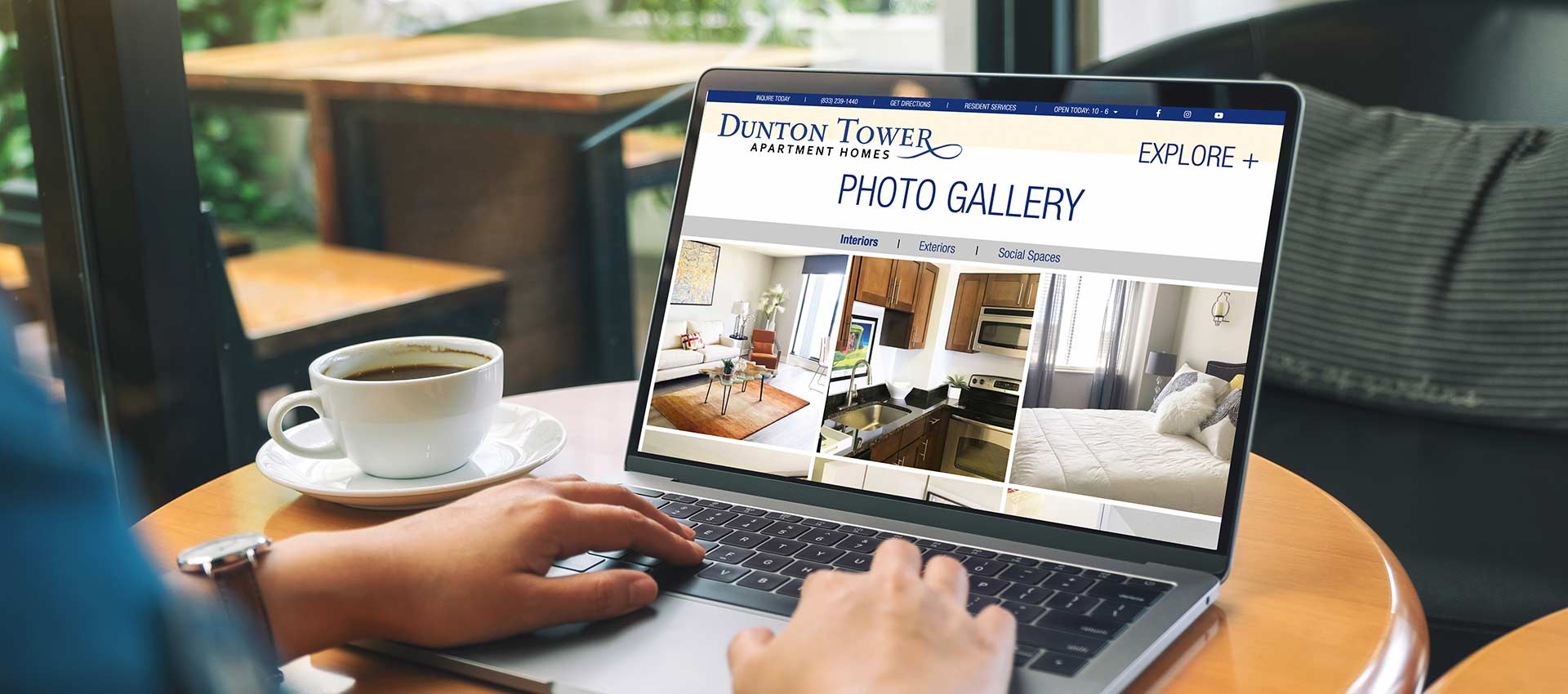 Person sitting at laptop viewing the Dunton Tower Apartments Website photo gallery, a TLC Management Company property